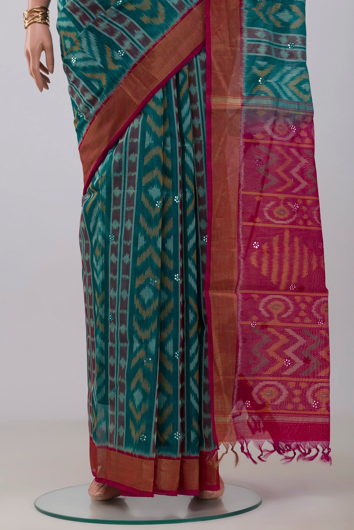 Pleats and pallu of Green Silk Cotton Saree with Ikat Print on the body and Zari Border. 