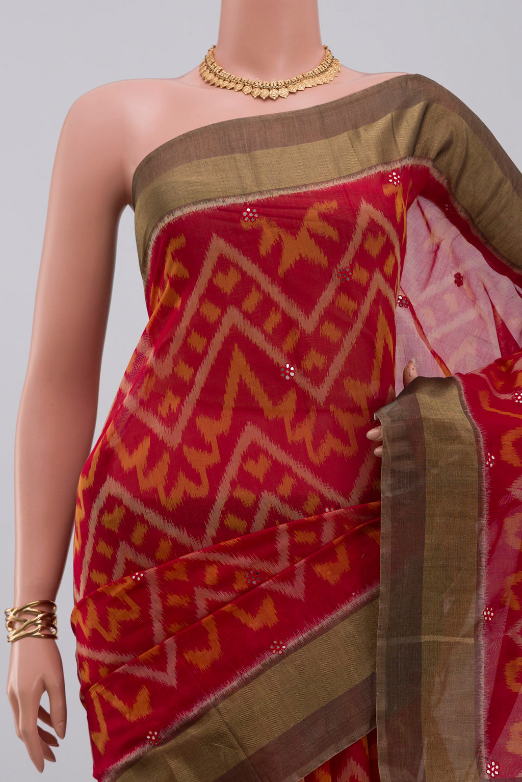 Border image of Red Silk Cotton Saree with Ikat Print on the body and Zari Border. 