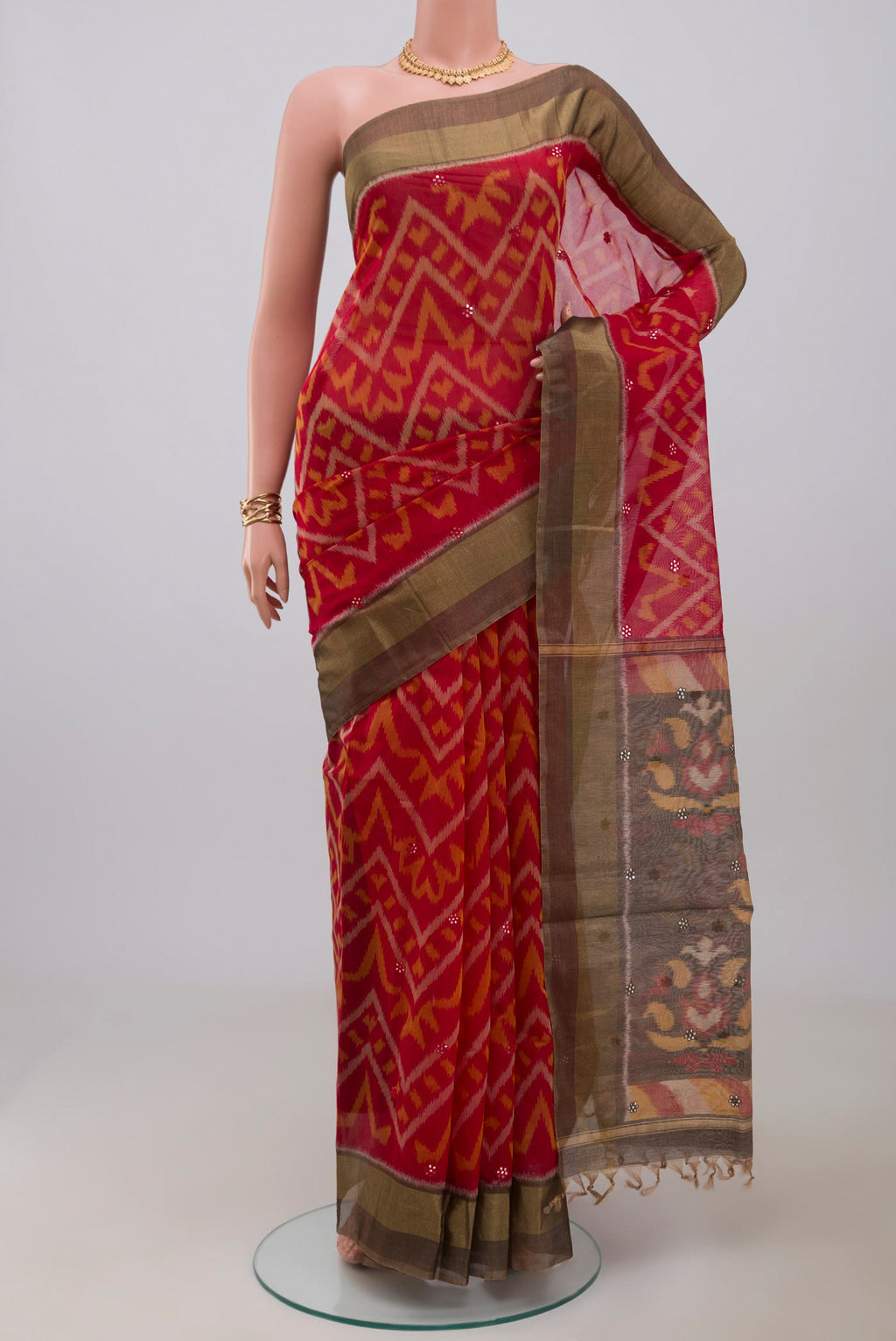 Red Silk Cotton Saree with Ikat Print on the body and Zari Border.  displayed on a mannequin