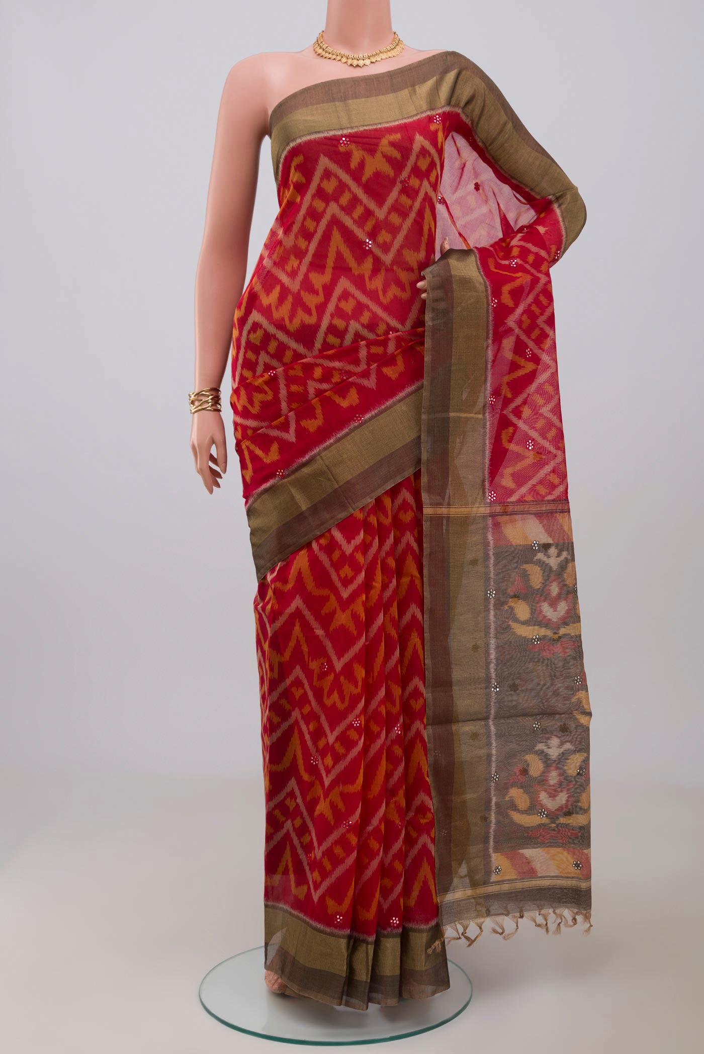Red Silk Cotton Saree with Ikat Print on the body and Zari Border.  displayed on a mannequin