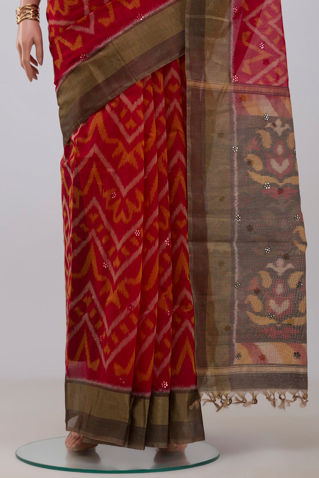 Pleats and pallu of Red Silk Cotton Saree with Ikat Print on the body and Zari Border. 