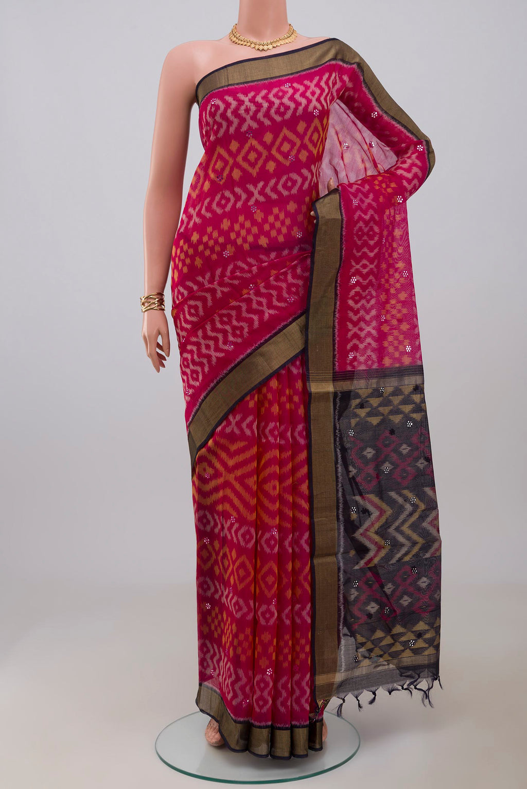 Pink Silk Cotton Saree with Ikat Print on the body and Zari Border.  displayed on a mannequin