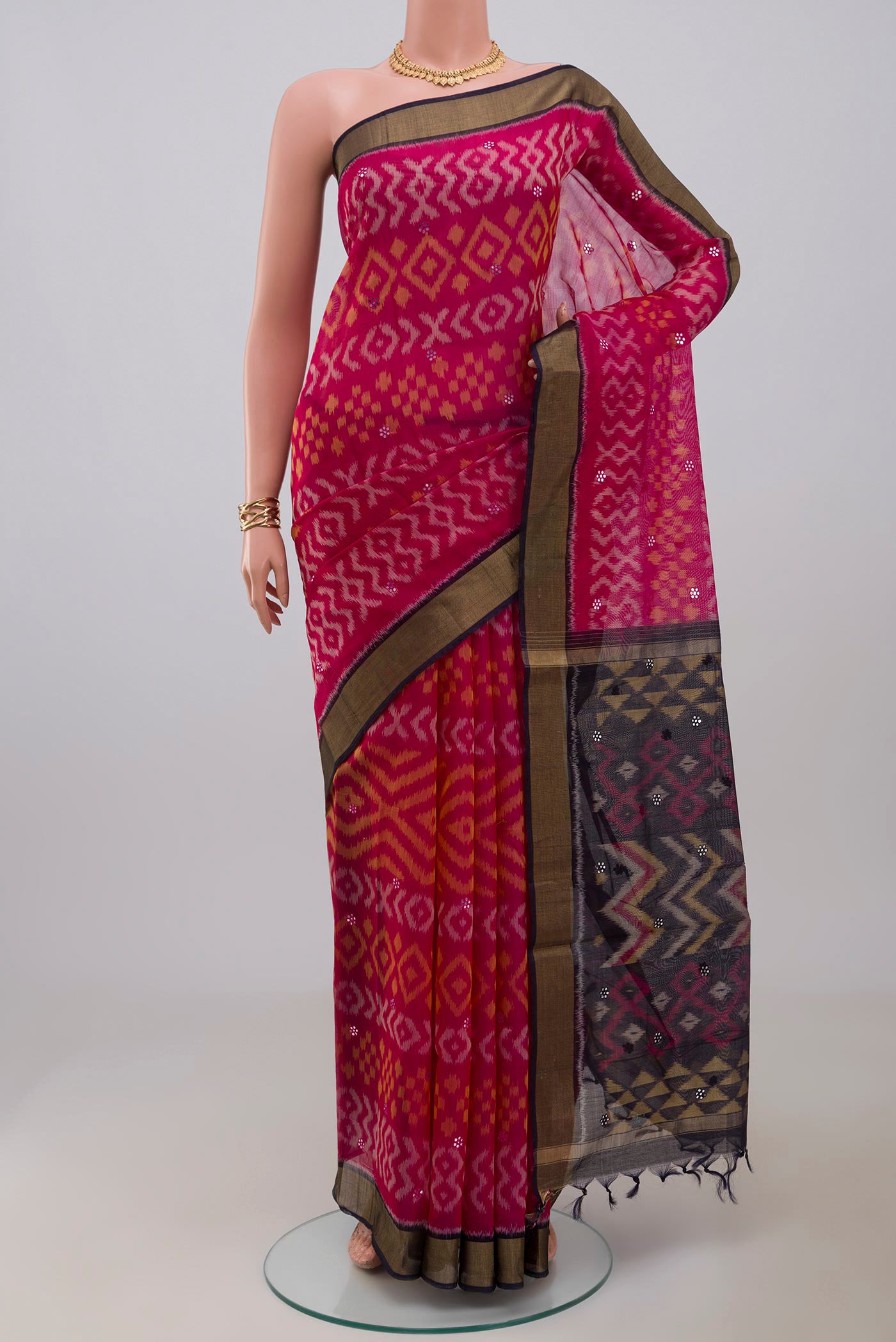 Pink Silk Cotton Saree with Ikat Print on the body and Zari Border.  displayed on a mannequin