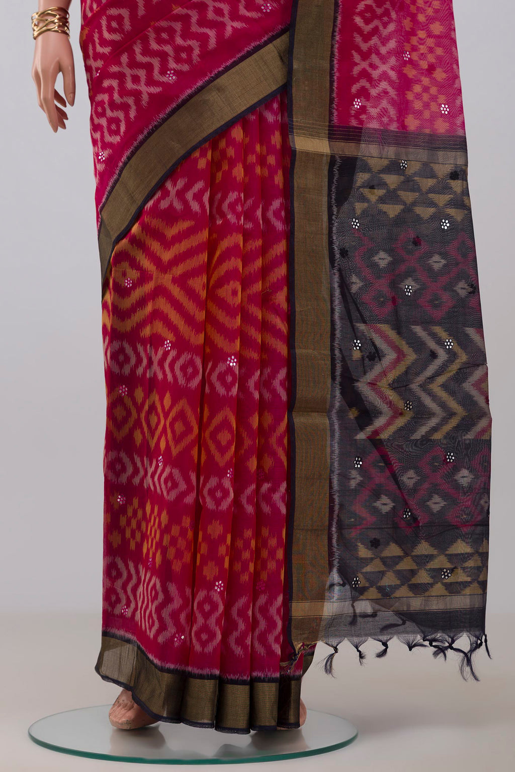 Pleats and pallu of Pink Silk Cotton Saree with Ikat Print on the body and Zari Border. 