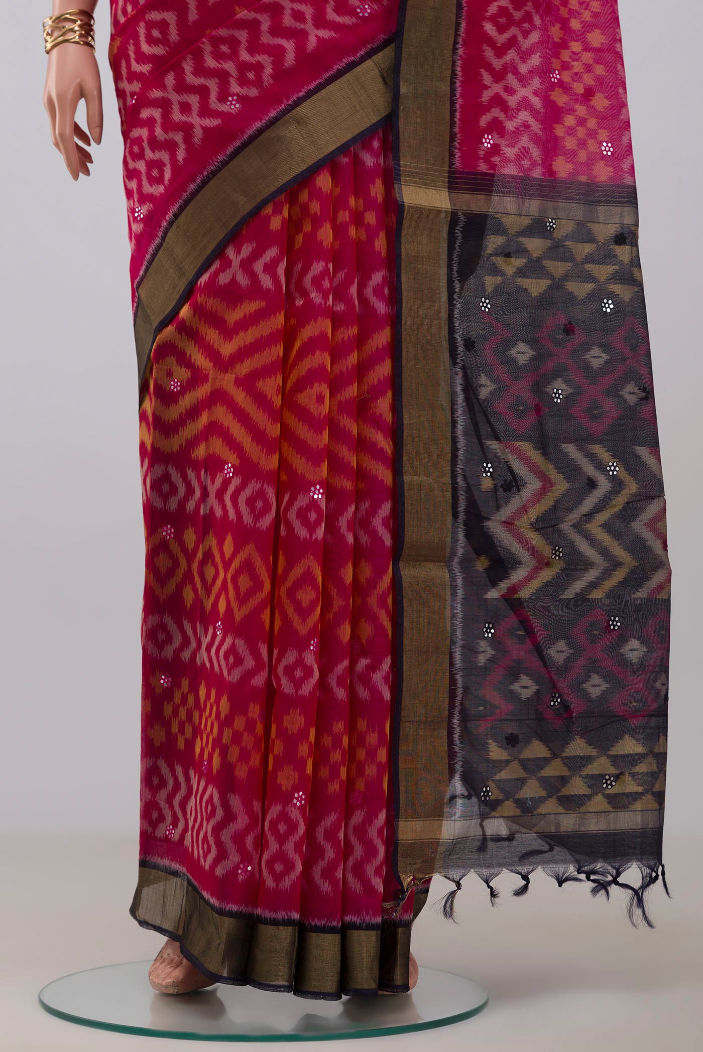 Pleats and pallu of Pink Silk Cotton Saree with Ikat Print on the body and Zari Border. 