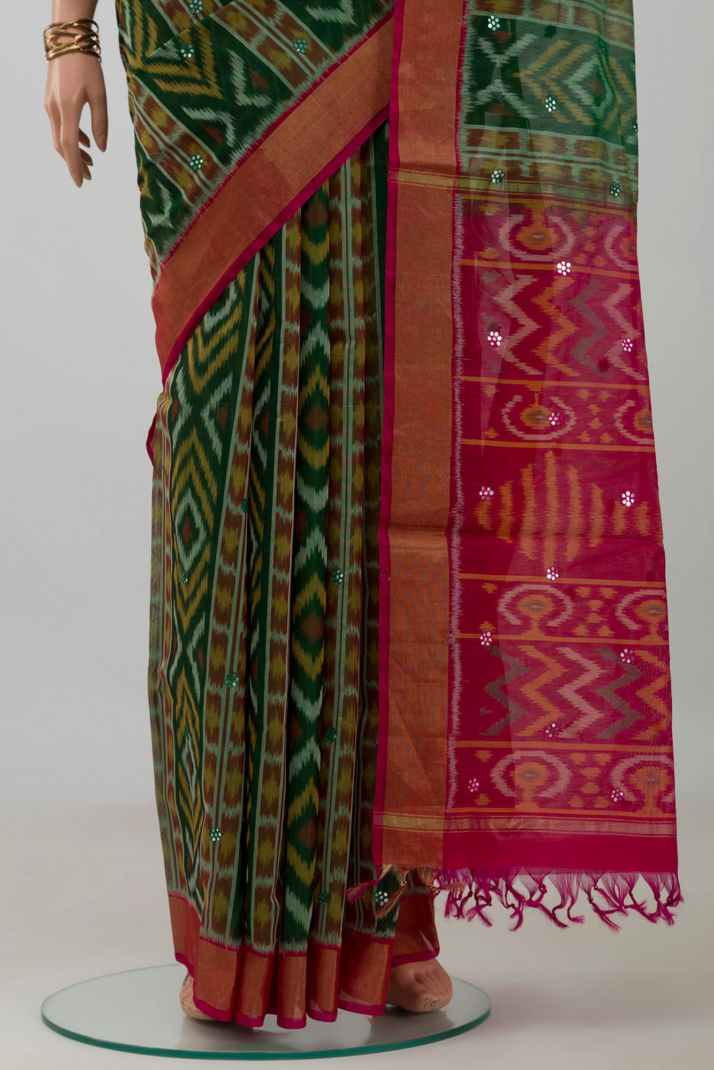Pleats and pallu of Green Silk Cotton Saree with Ikat design on the body and Zari Border. 