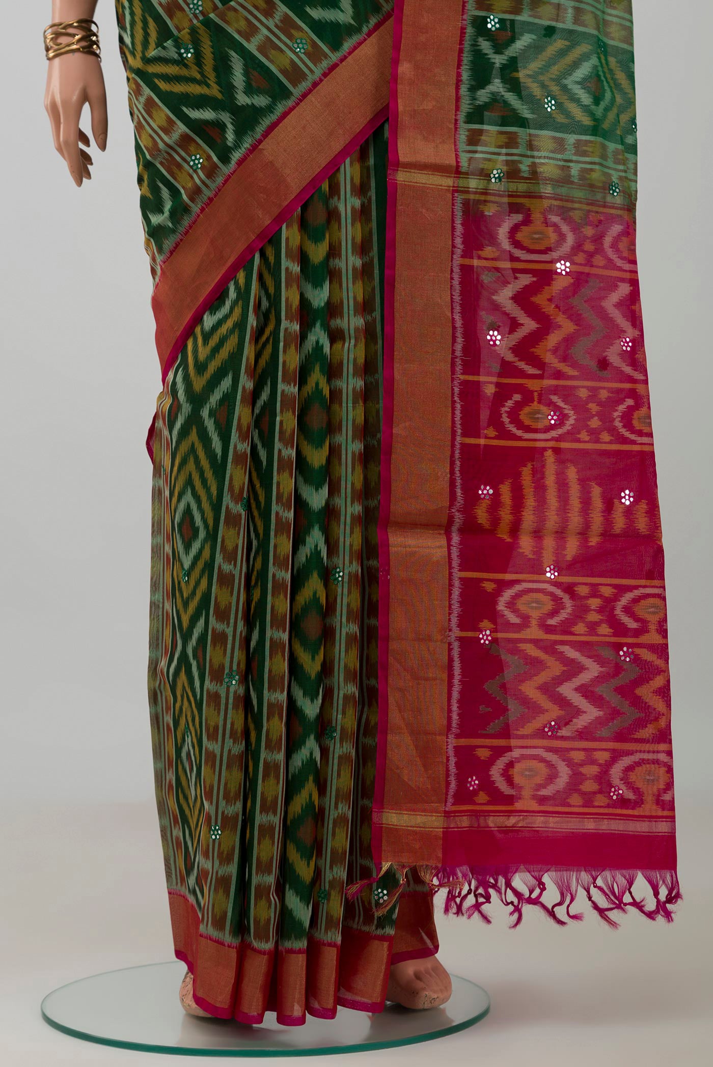 Pleats and pallu of Green Silk Cotton Saree with Ikat design on the body and Zari Border. 