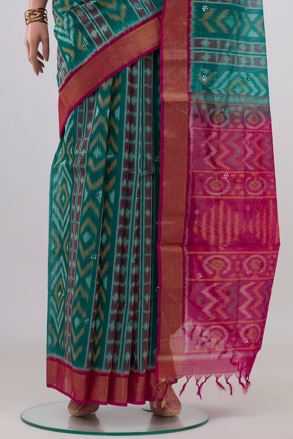 Pleats and pallu of Green Silk Cotton Saree with Ikat design on the body and Zari Border. 