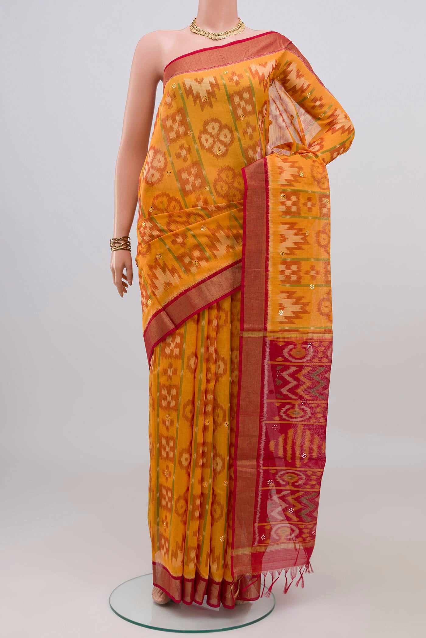 Yellow Silk Cotton Saree with Ikat design on the body and Zari Border.  displayed on a mannequin