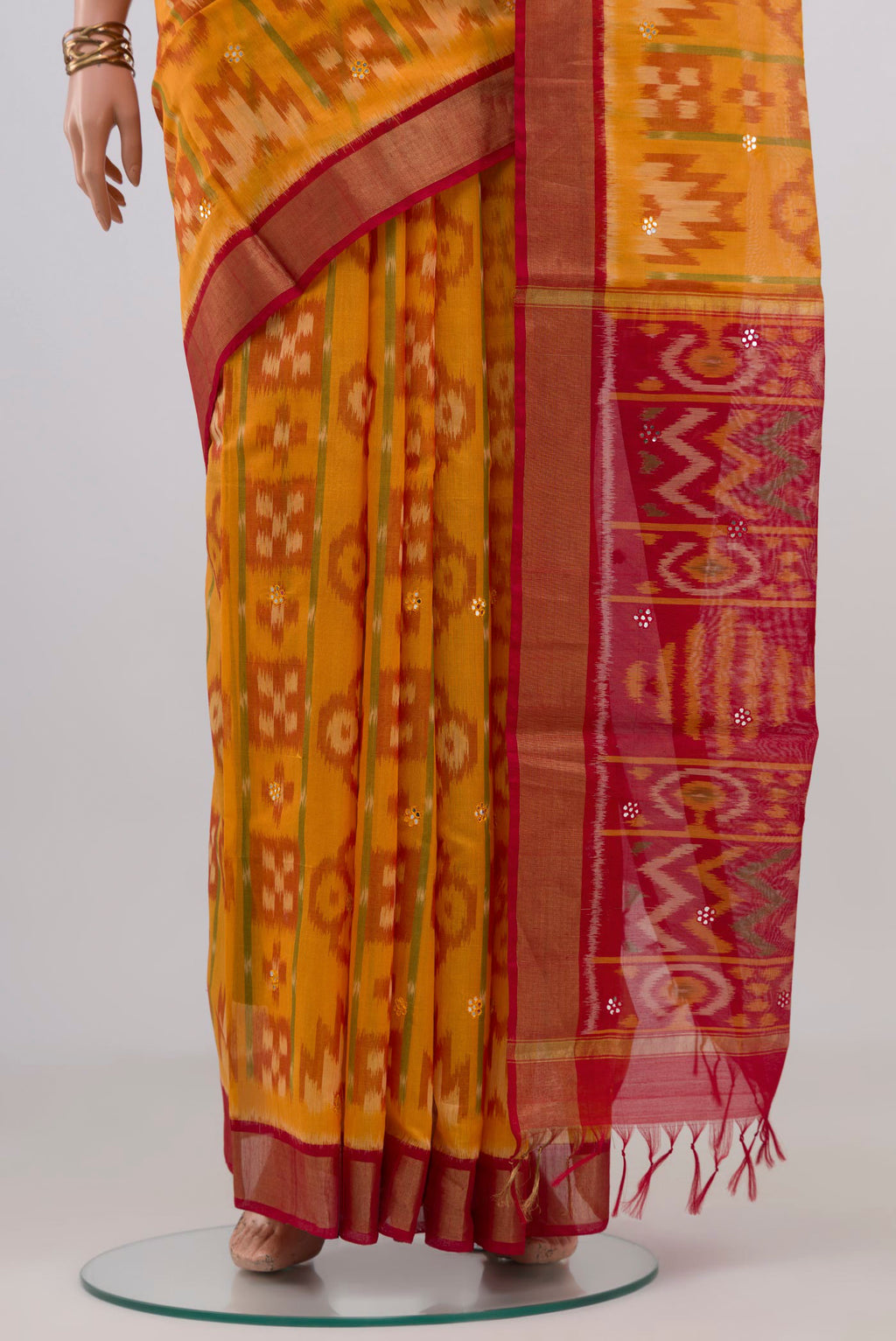Pleats and pallu of Yellow Silk Cotton Saree with Ikat design on the body and Zari Border. 