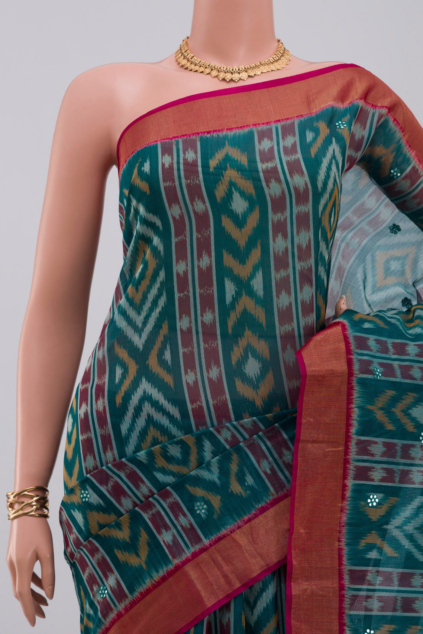 Border image of Green Silk Cotton Saree with Ikat Print on the body and Zari Border. 
