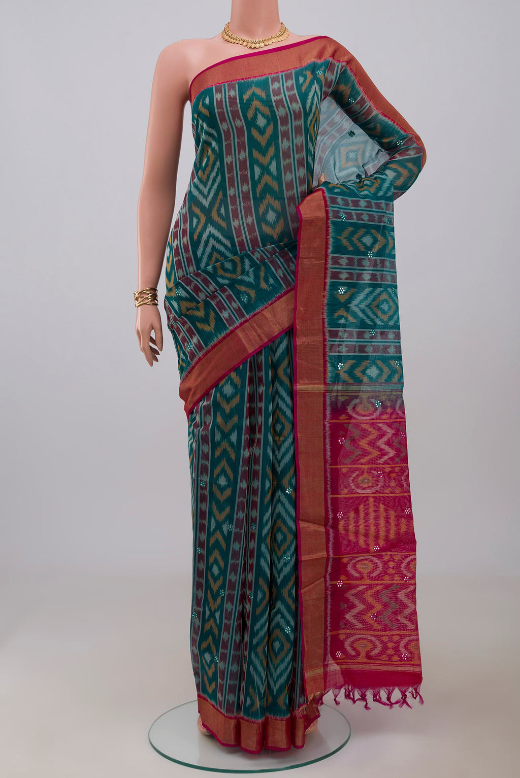 Green Silk Cotton Saree with Ikat Print on the body and Zari Border.  displayed on a mannequin