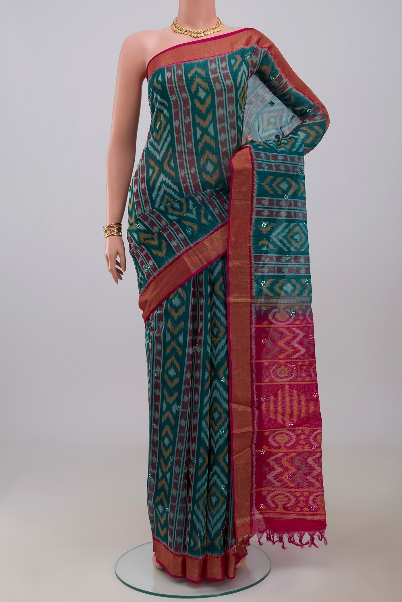 Green Silk Cotton Saree with Ikat Print on the body and Zari Border.  displayed on a mannequin