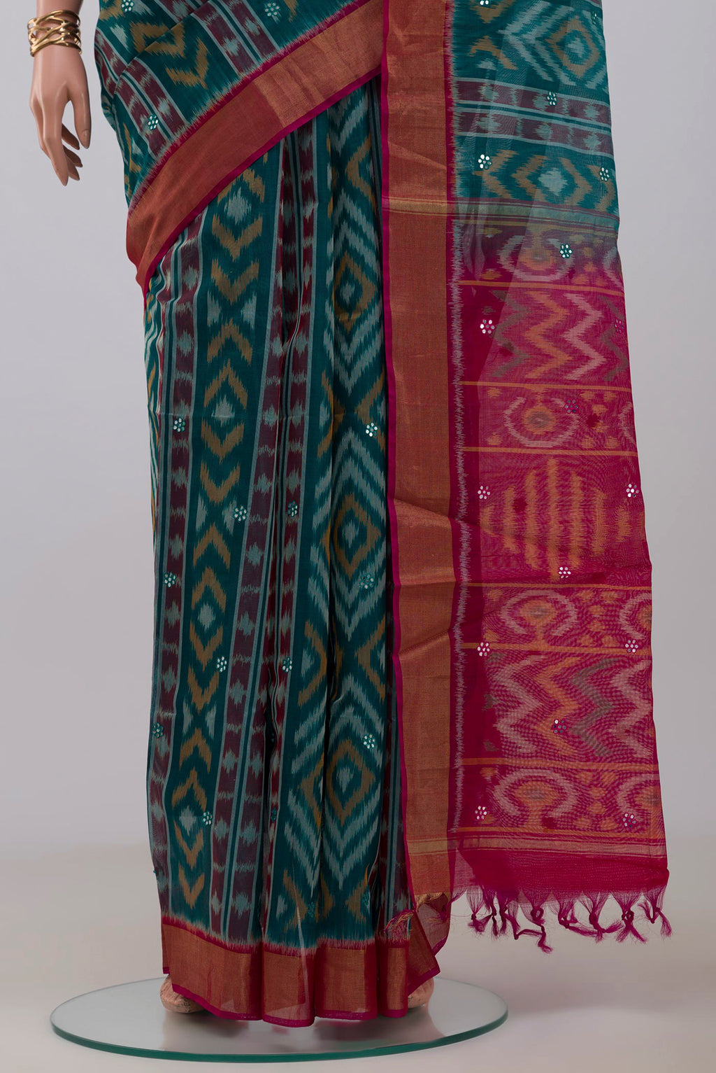 Pleats and pallu of Green Silk Cotton Saree with Ikat Print on the body and Zari Border. 