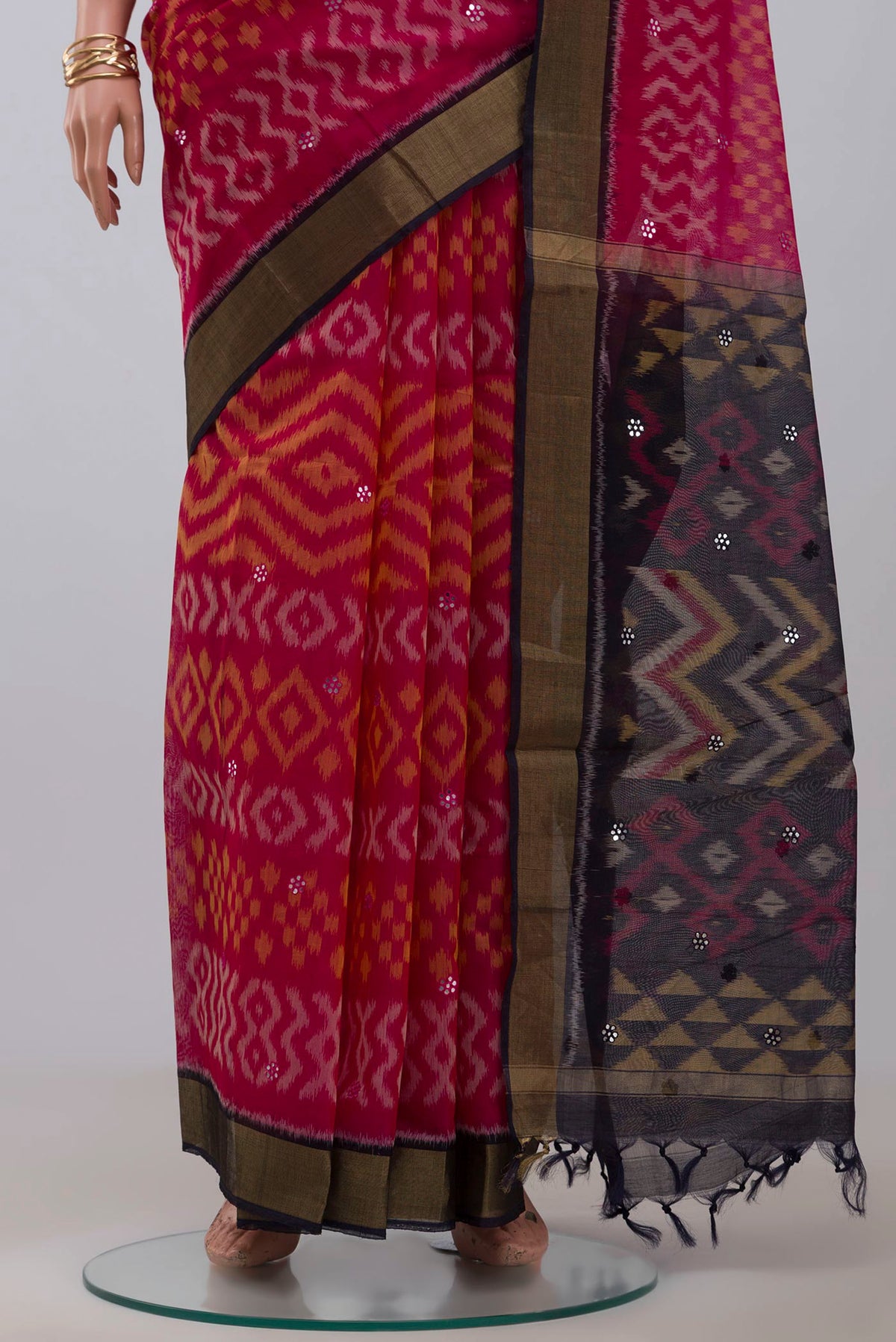 Pleats and pallu of Pink Silk Cotton Saree with Ikat design on the body and Zari Border. 