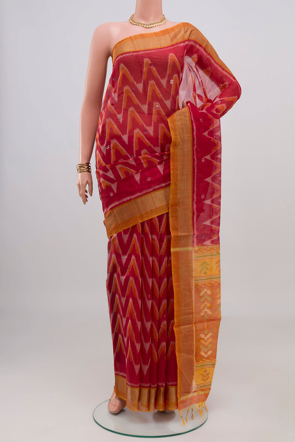 Red Silk Cotton Saree with Ikat Print on the body and Zari Border.  displayed on a mannequin