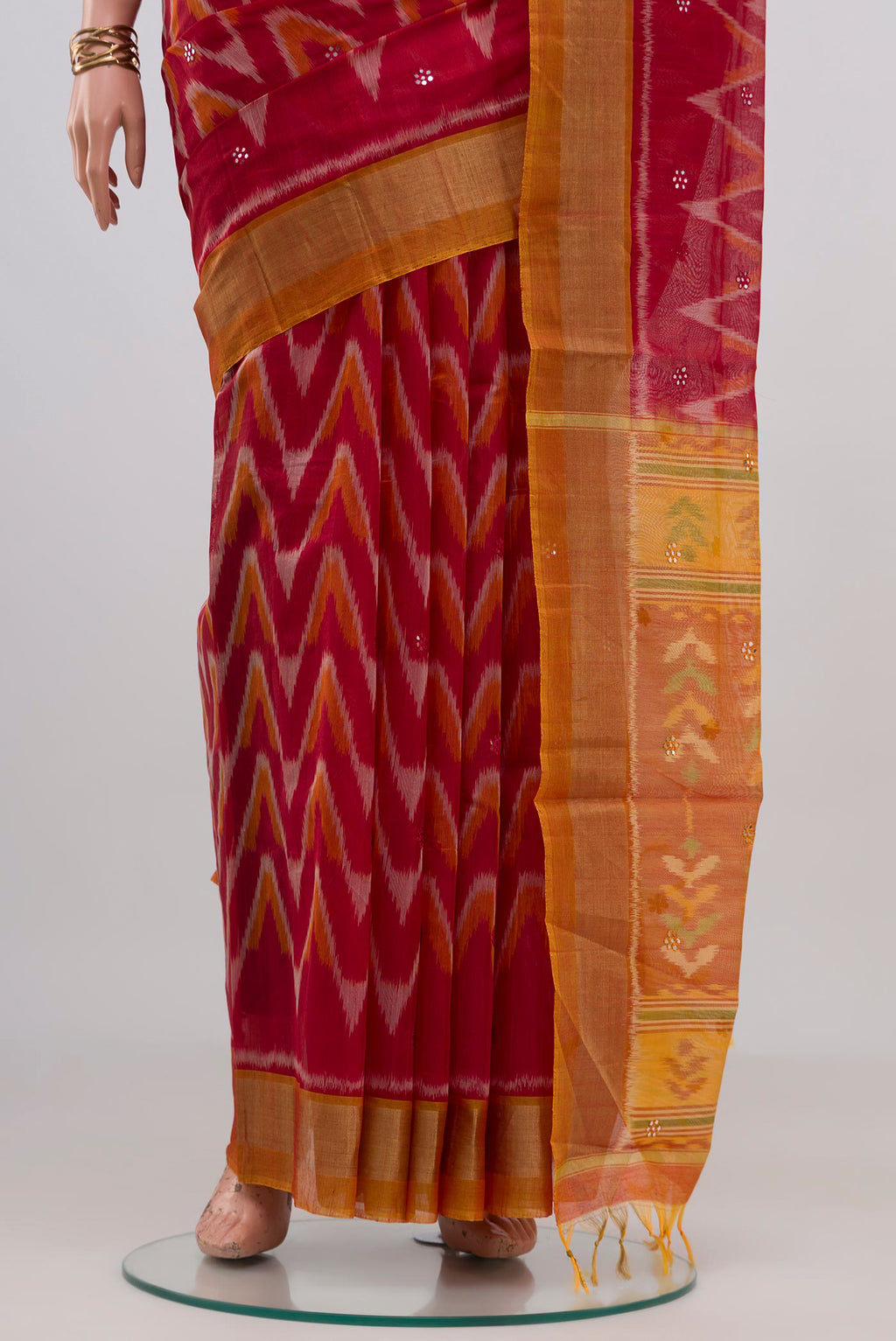 Pleats and pallu of Red Silk Cotton Saree with Ikat Print on the body and Zari Border. 