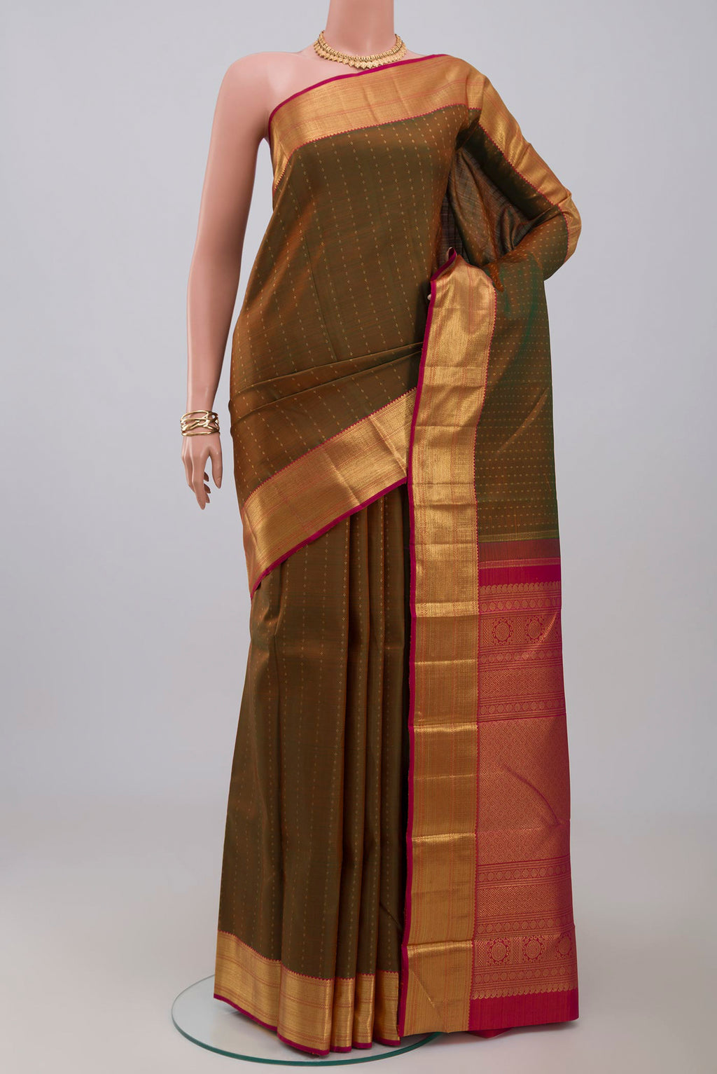 Pure Silk Pure Zari Green Kanjivaram Saree with Zari Butta on the body and Zari Border.  displayed on a mannequin