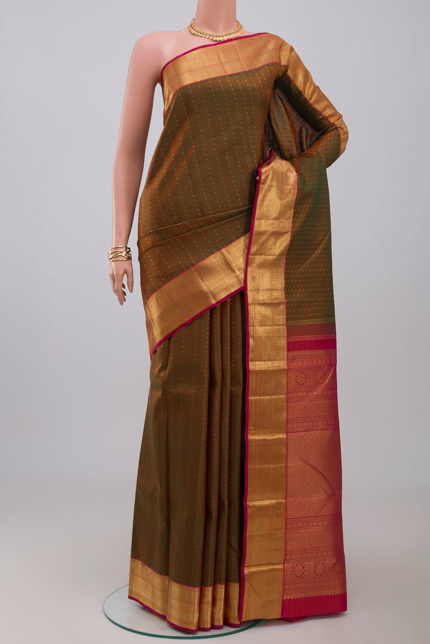 Pure Silk Pure Zari Green Kanjivaram Saree with Zari Butta on the body and Zari Border.  displayed on a mannequin