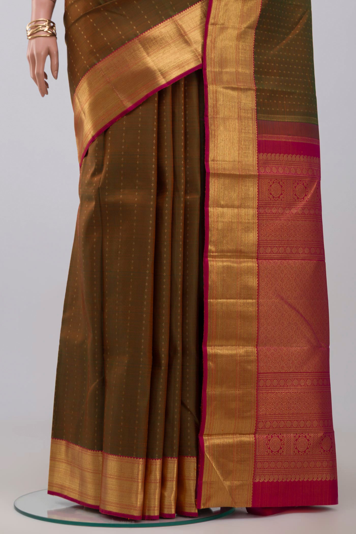 Pleats and pallu of Pure Silk Pure Zari Green Kanjivaram Saree with Zari Butta on the body and Zari Border. 
