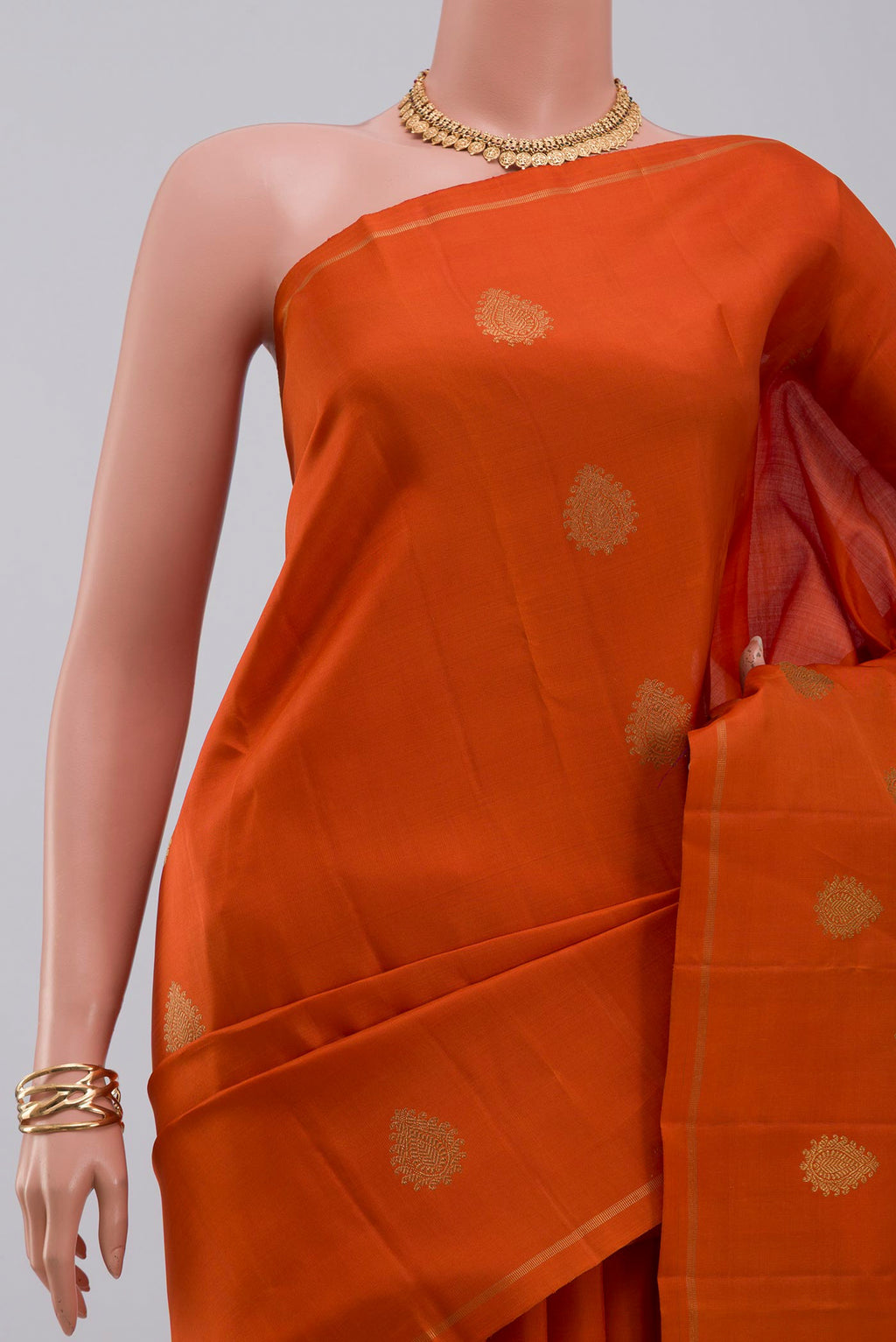Border image of Pure Silk Pure Zari Orange Kanchipuram Saree with Zari Butta on the body and Thin Zari Line. 