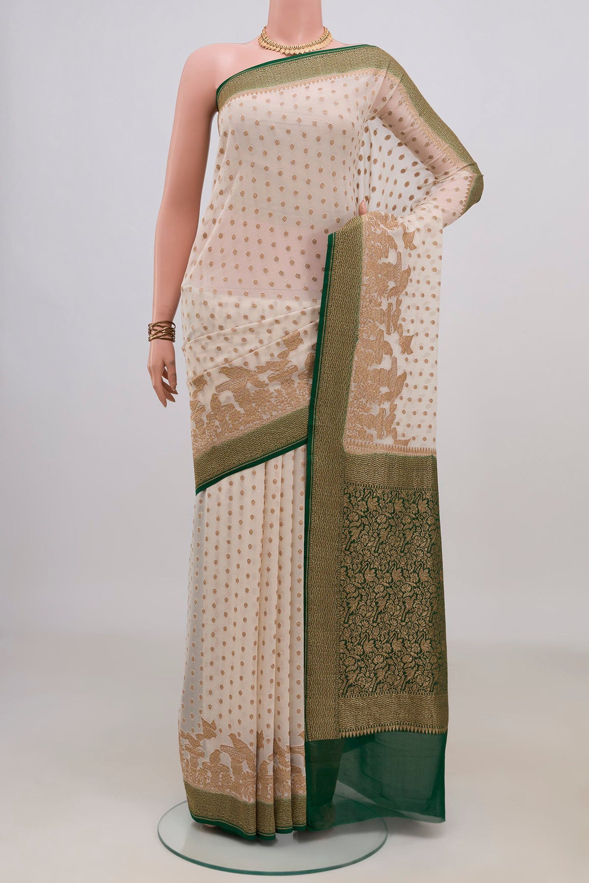 Off White Banarasi Georgette Saree with Zari Butta on the body and Fancy Border.  displayed on a mannequin