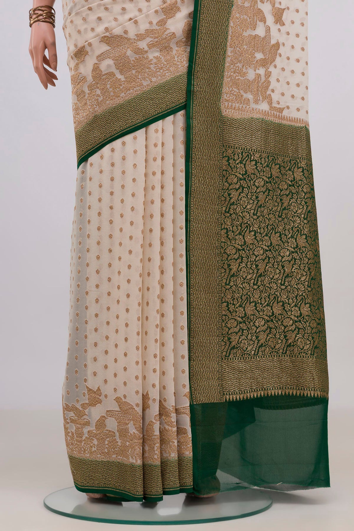 Pleats and pallu of Off White Banarasi Georgette Saree with Zari Butta on the body and Fancy Border. 