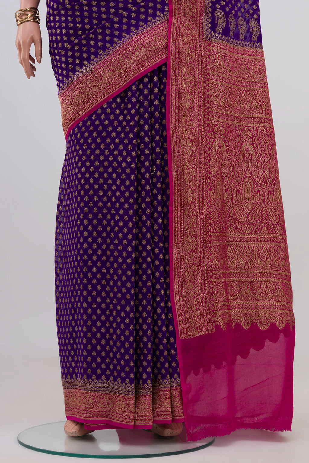 Pleats and pallu of Violet Banarasi Georgette Saree with Zari Butta on the body and Zari Border. 