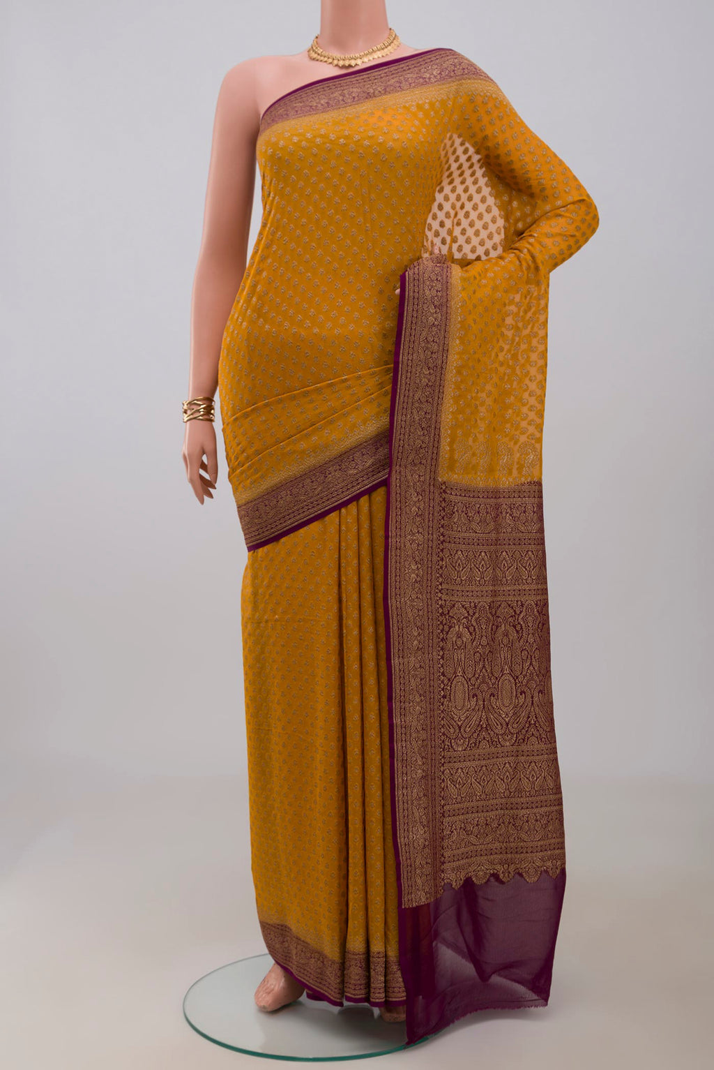 Yellow Georgette Saree with Fancy on the body and Fancy Border.  displayed on a mannequin