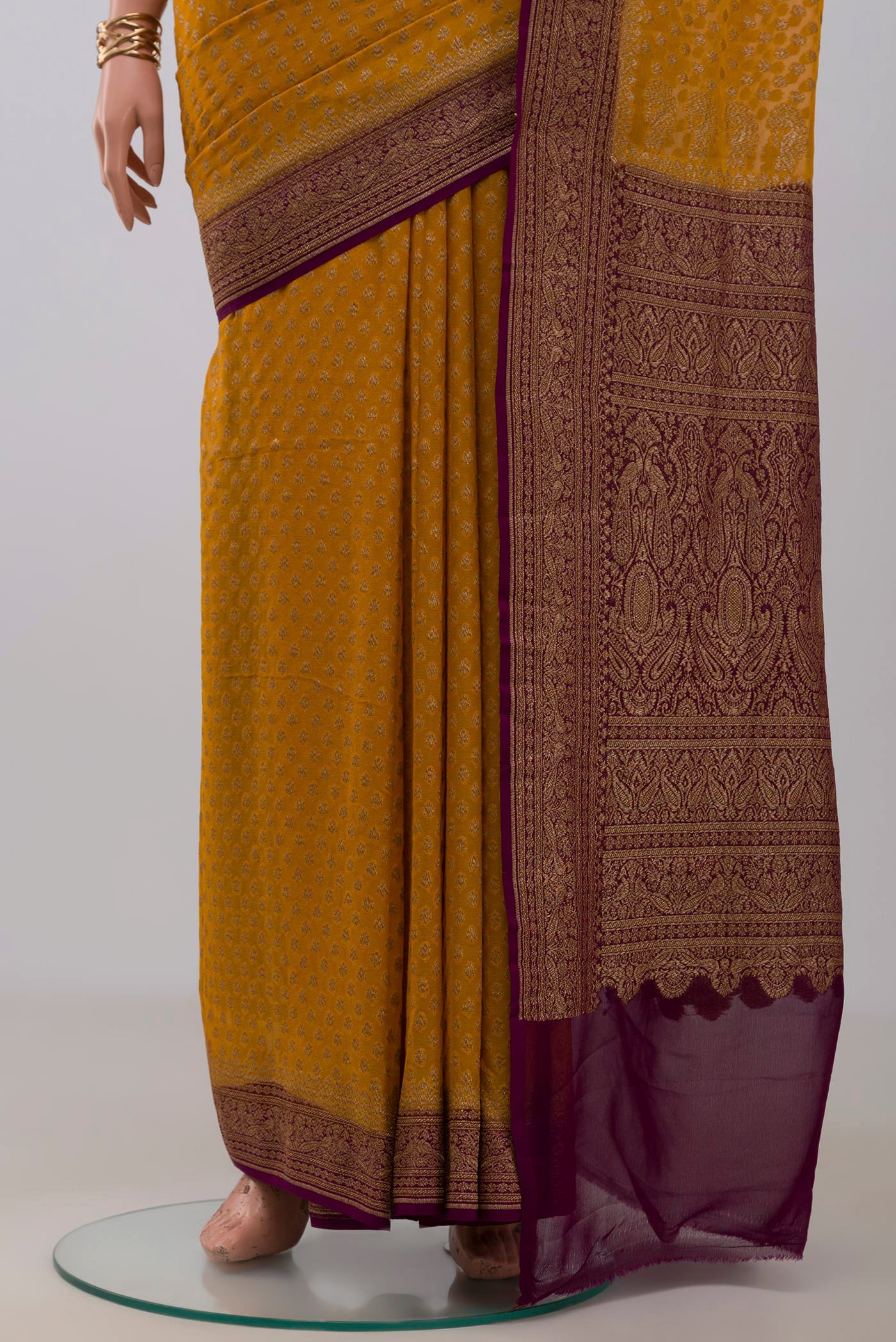 Pleats and pallu of Yellow Georgette Saree with Fancy on the body and Fancy Border. 