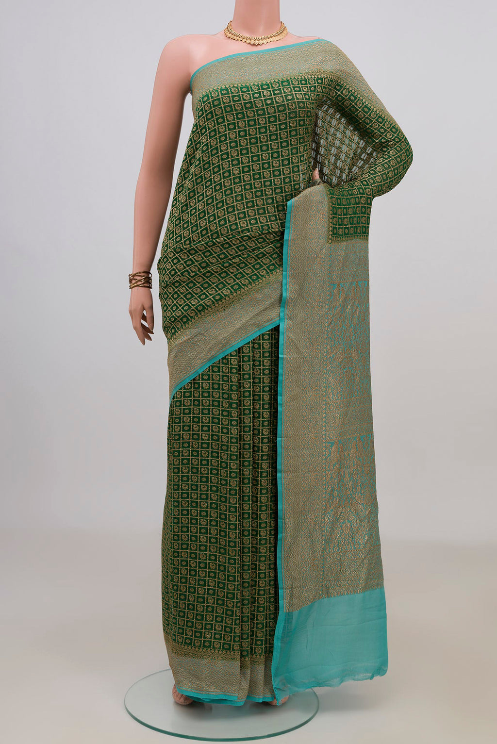 Green Banarasi Georgette Saree with Checked design on the body and Zari Border.  displayed on a mannequin