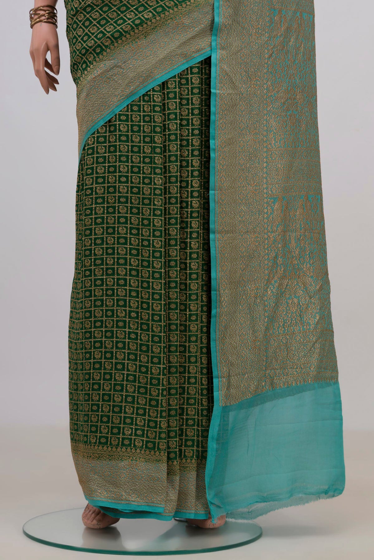 Pleats and pallu of Green Banarasi Georgette Saree with Checked design on the body and Zari Border. 