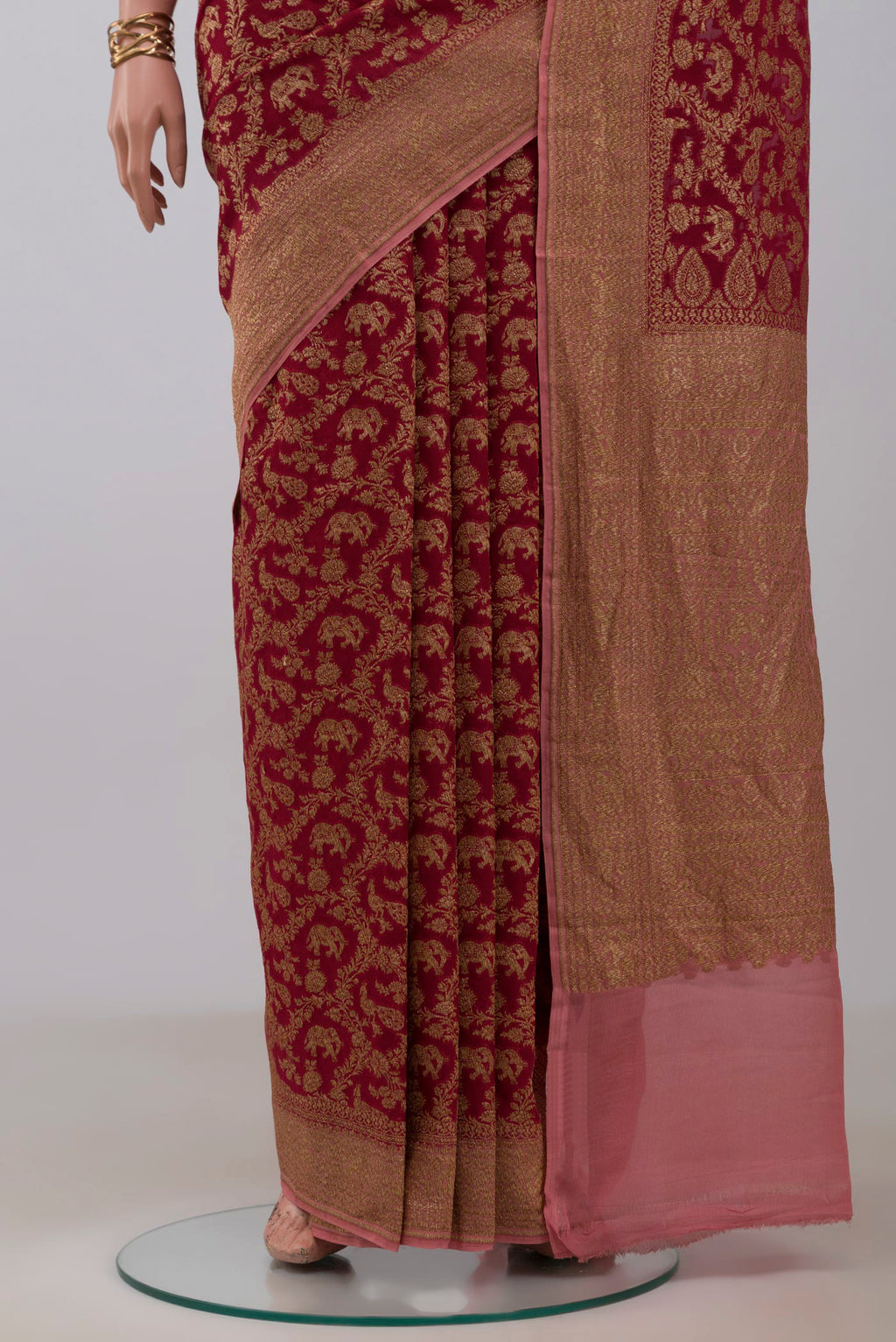 Pleats and pallu of Maroon Banarasi Georgette Saree with Zari Brocade on the body and Zig Zag Border. 