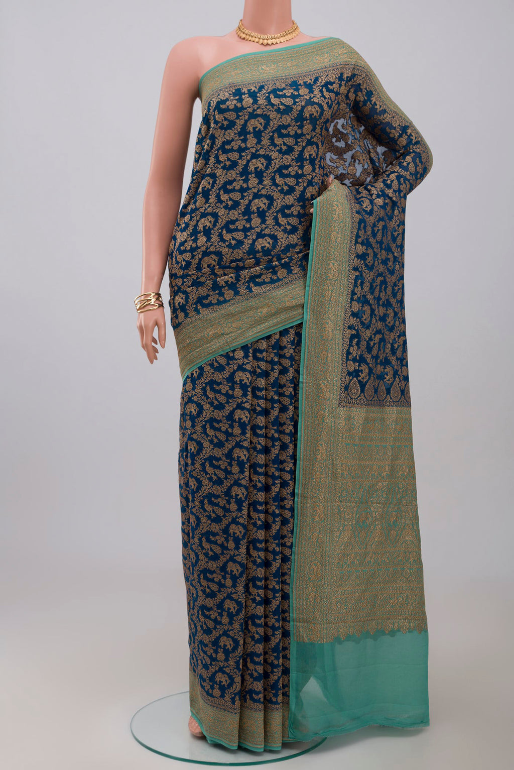 Blue Georgette Saree with Fancy on the body and Zari Border.  displayed on a mannequin
