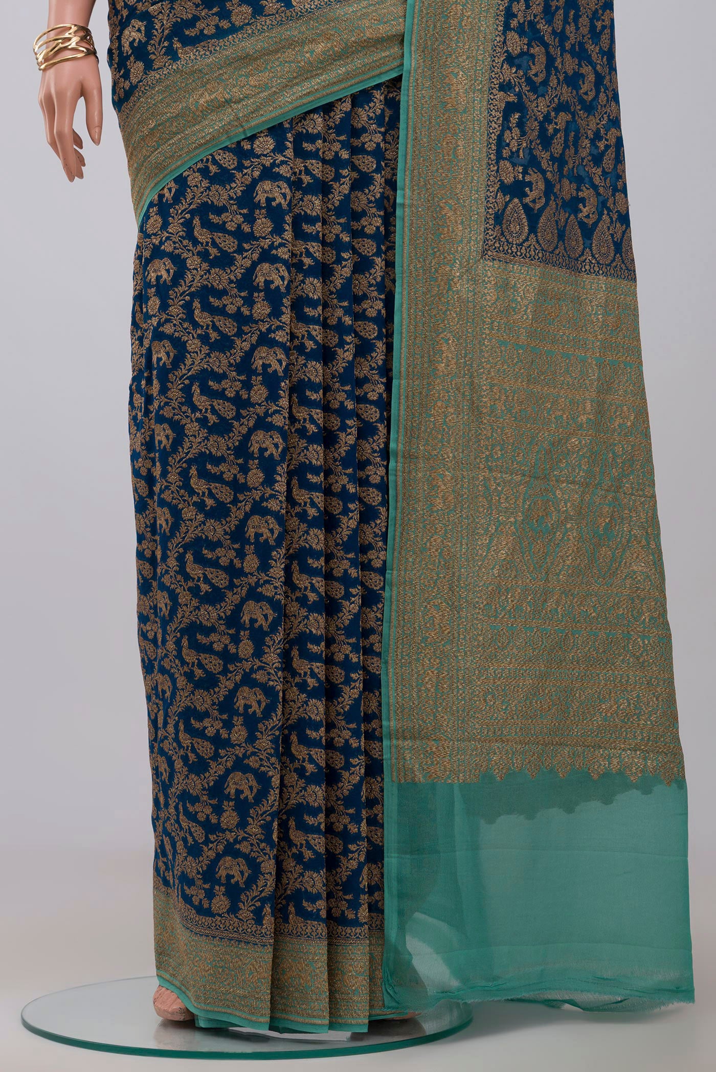 Pleats and pallu of Blue Georgette Saree with Fancy on the body and Zari Border. 
