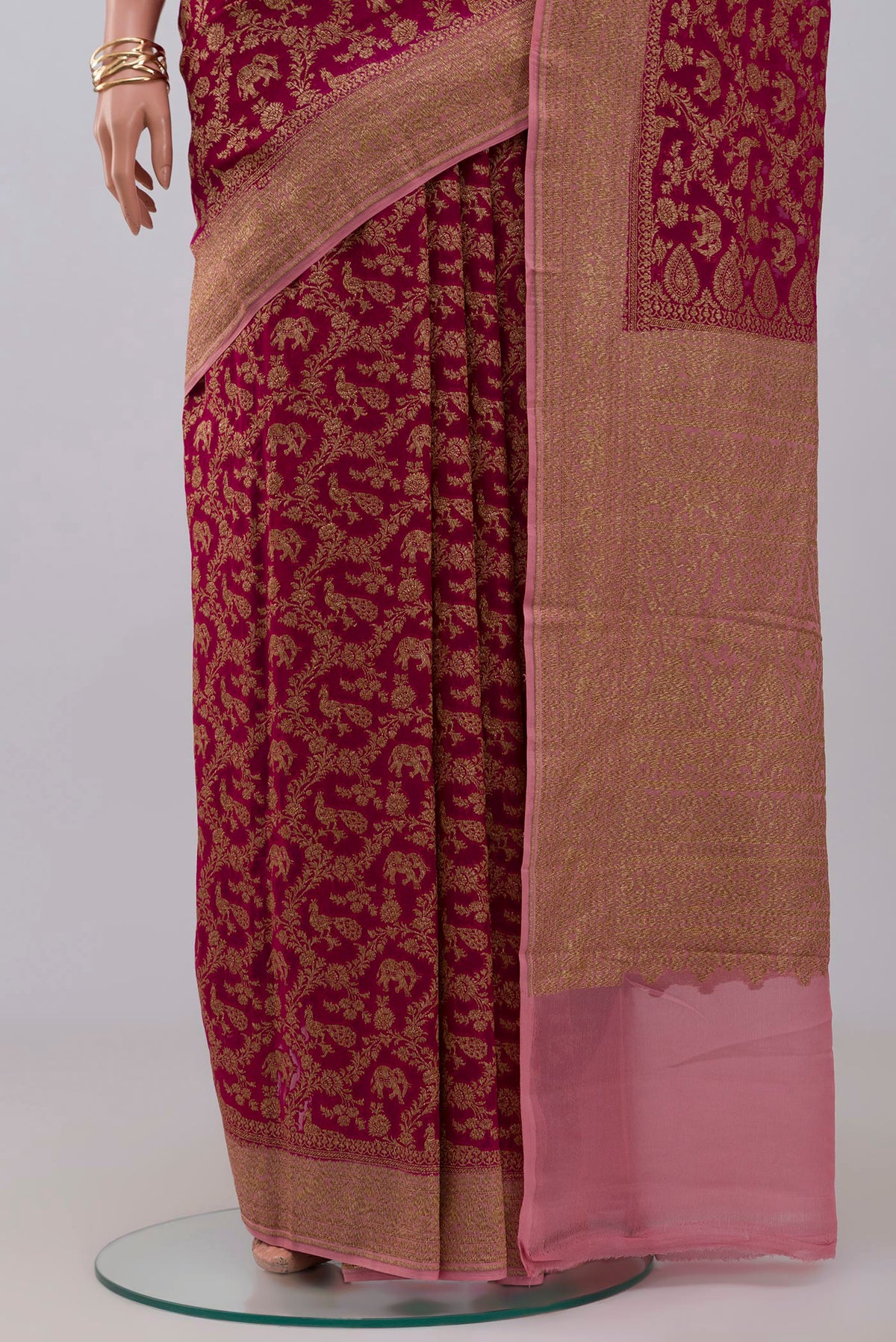 Pleats and pallu of Pink Georgette Saree with Fancy on the body and Zari Border. 