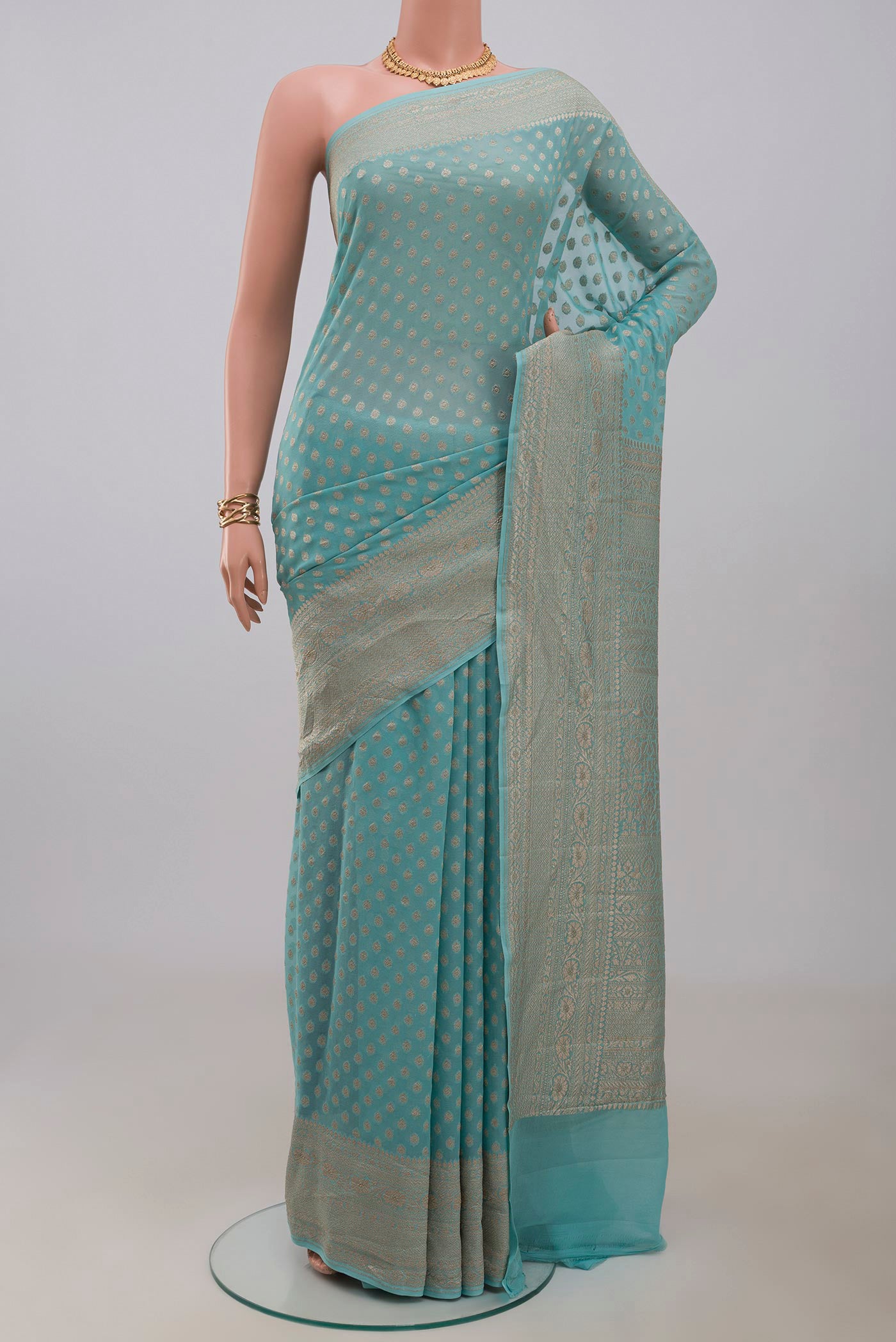 Blue Georgette Saree with Fancy on the body and Fancy Border.  displayed on a mannequin
