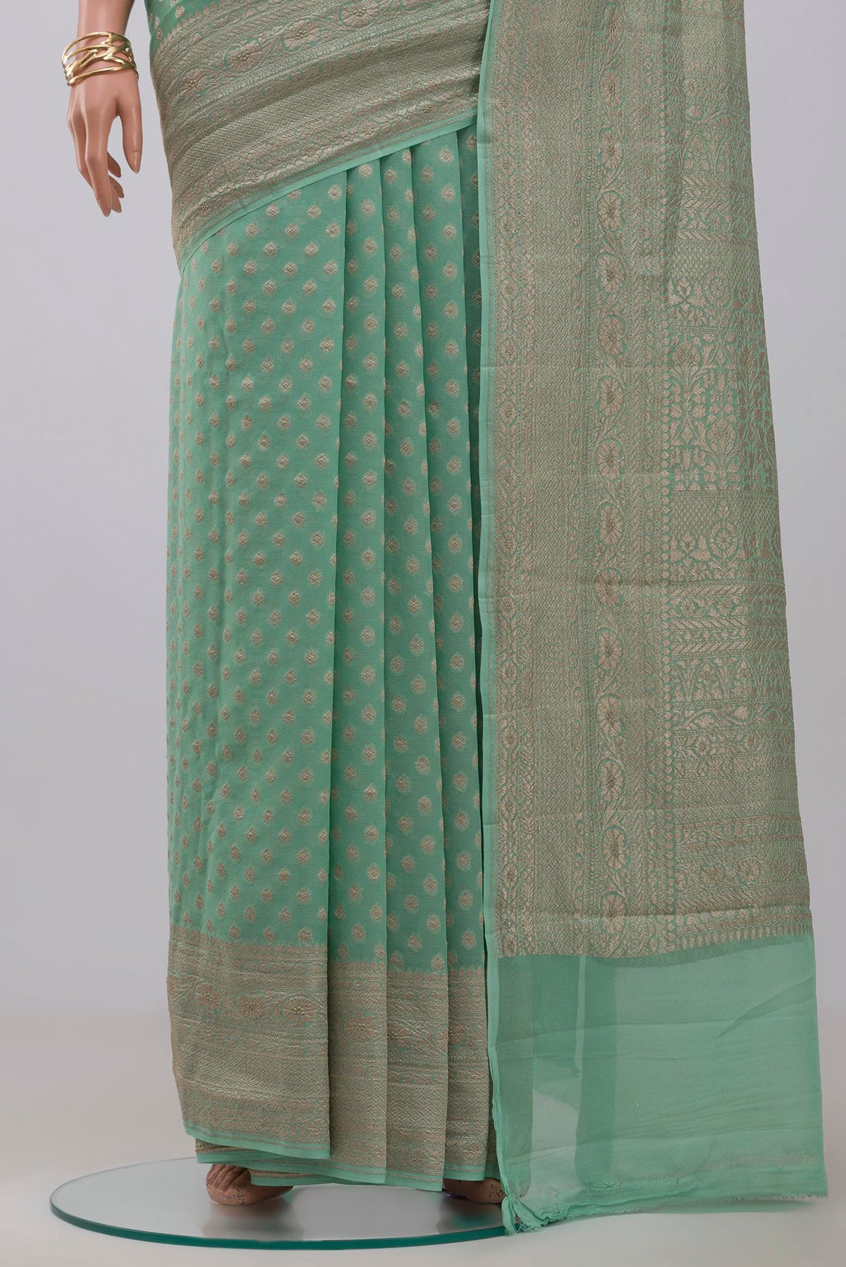 Pleats and pallu of Pista Green Georgette Saree with Fancy on the body and Zari Border. 