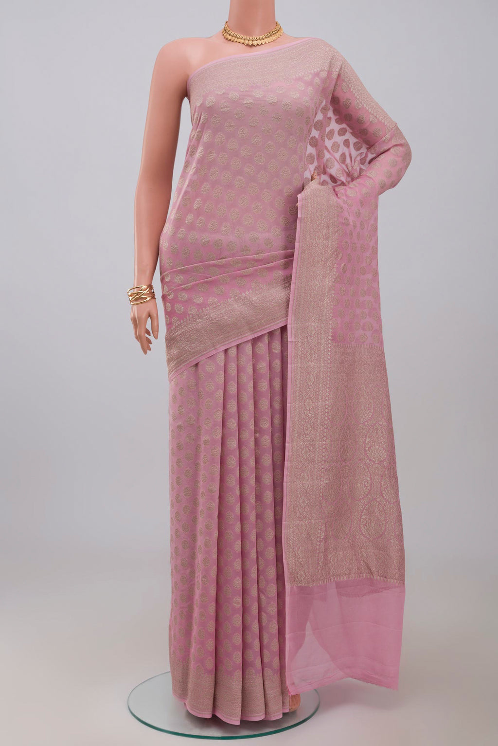 Pink Georgette Saree with Fancy on the body and Zari Border.  displayed on a mannequin