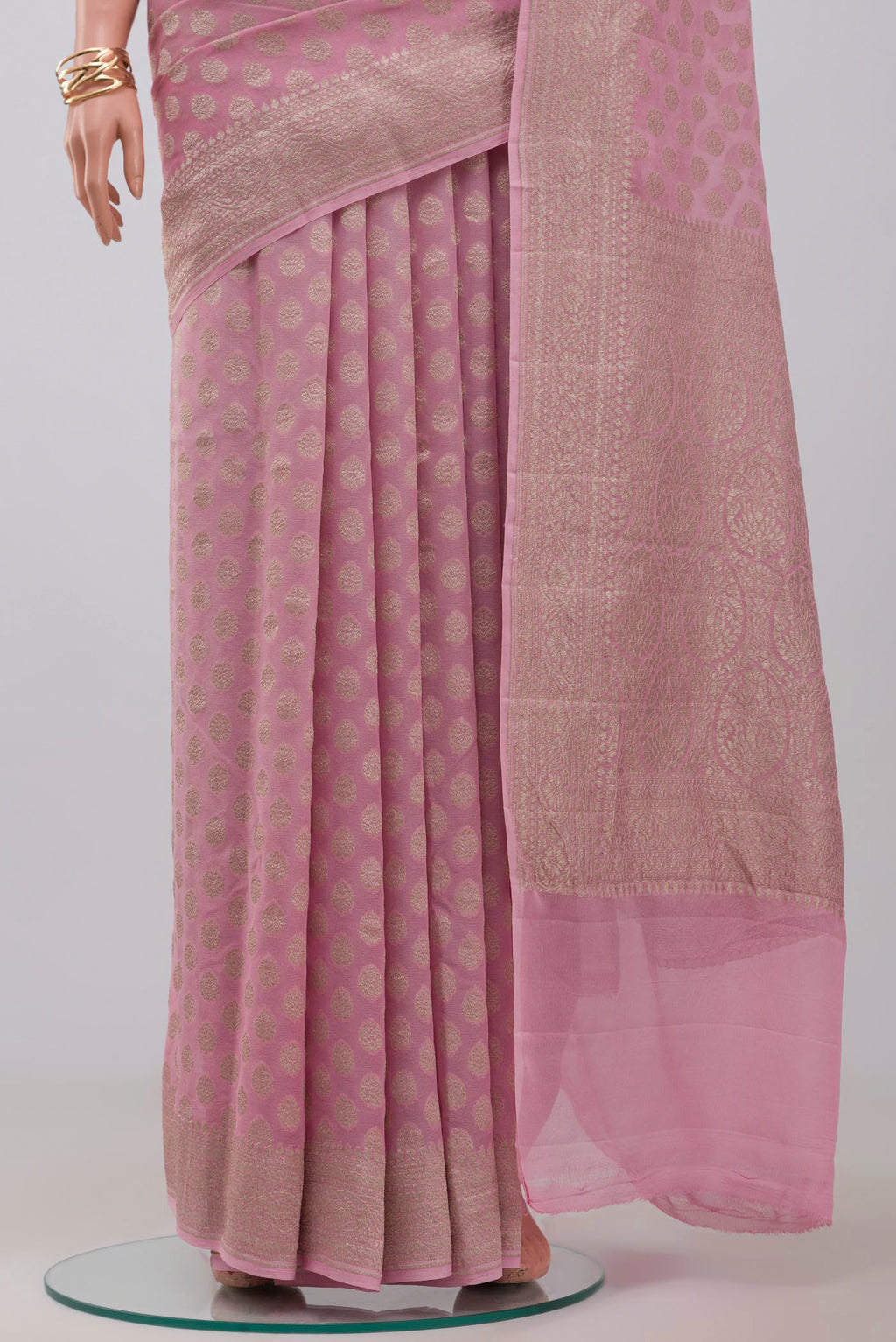 Pleats and pallu of Pink Georgette Saree with Fancy on the body and Zari Border. 