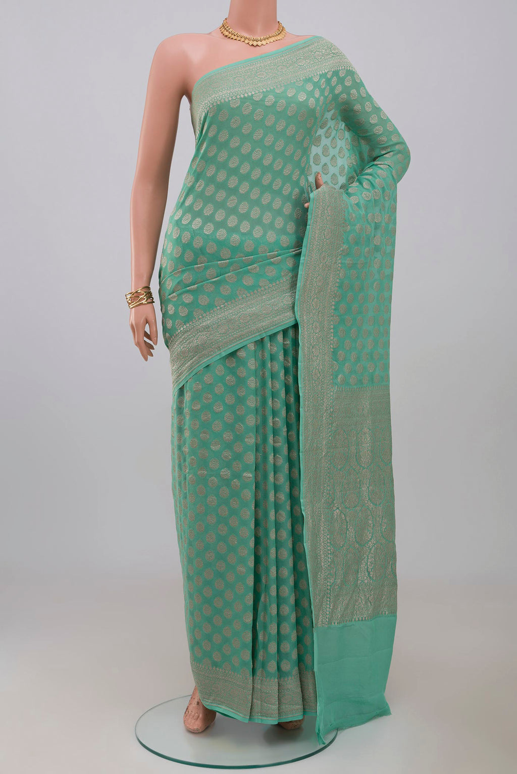 Blue Georgette Saree with Fancy on the body and Fancy Border.  displayed on a mannequin