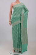 Blue Georgette Saree with Fancy on the body and Fancy Border.  displayed on a mannequin