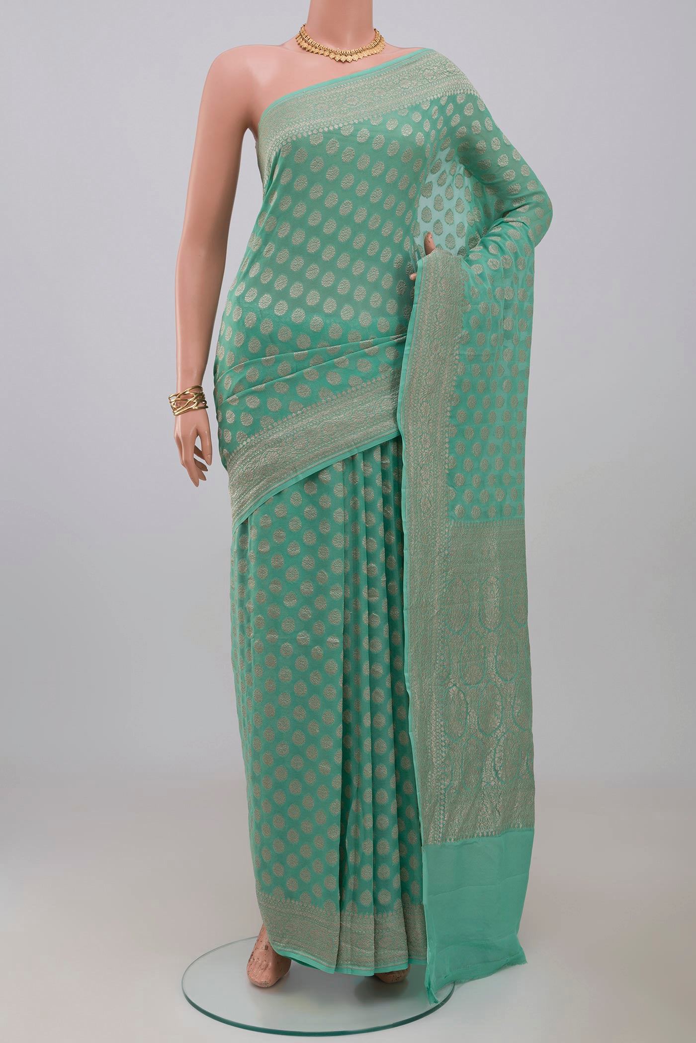 Blue Georgette Saree with Fancy on the body and Fancy Border.  displayed on a mannequin