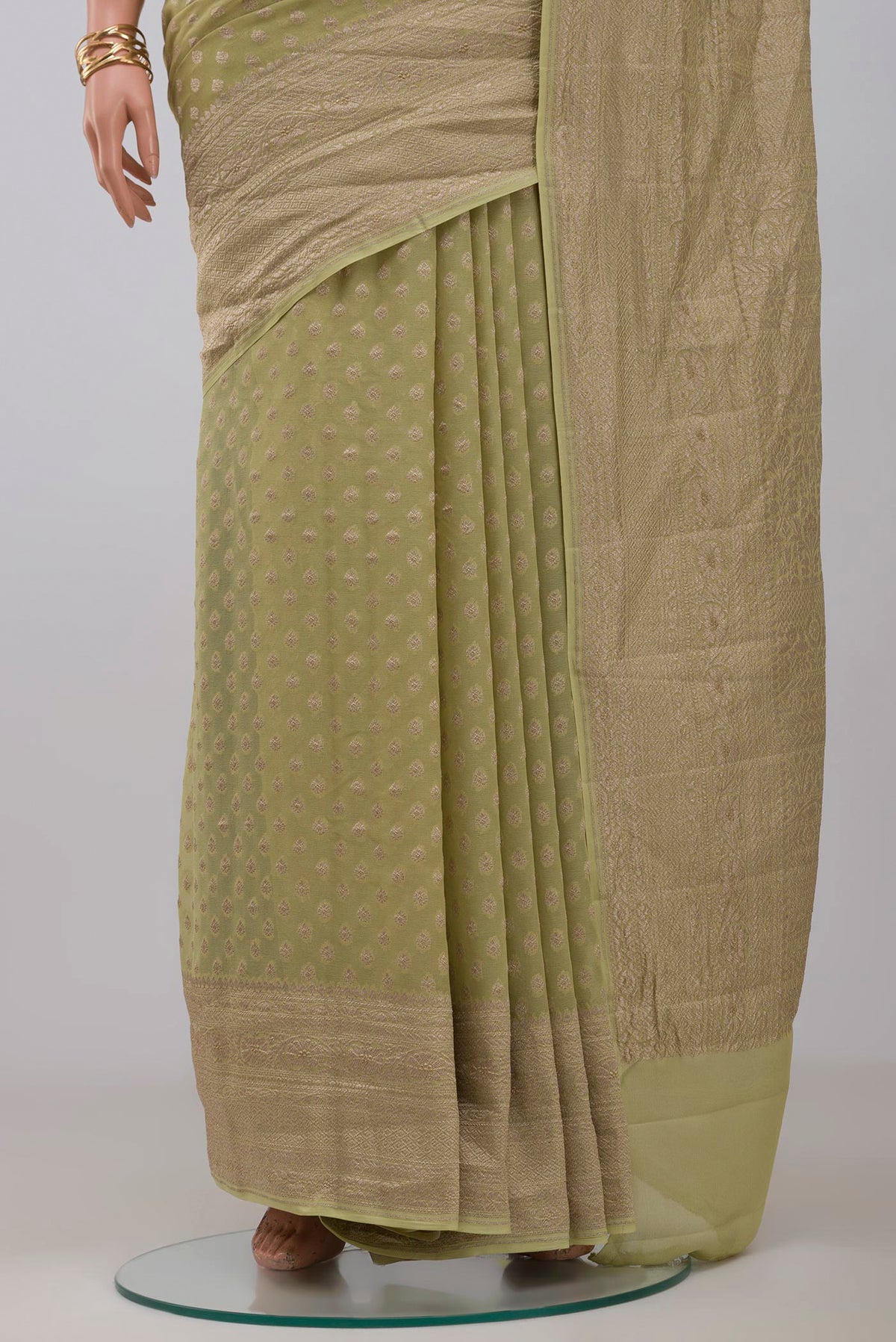 Pleats and pallu of Green Georgette Saree with Fancy on the body and Zari Border. 