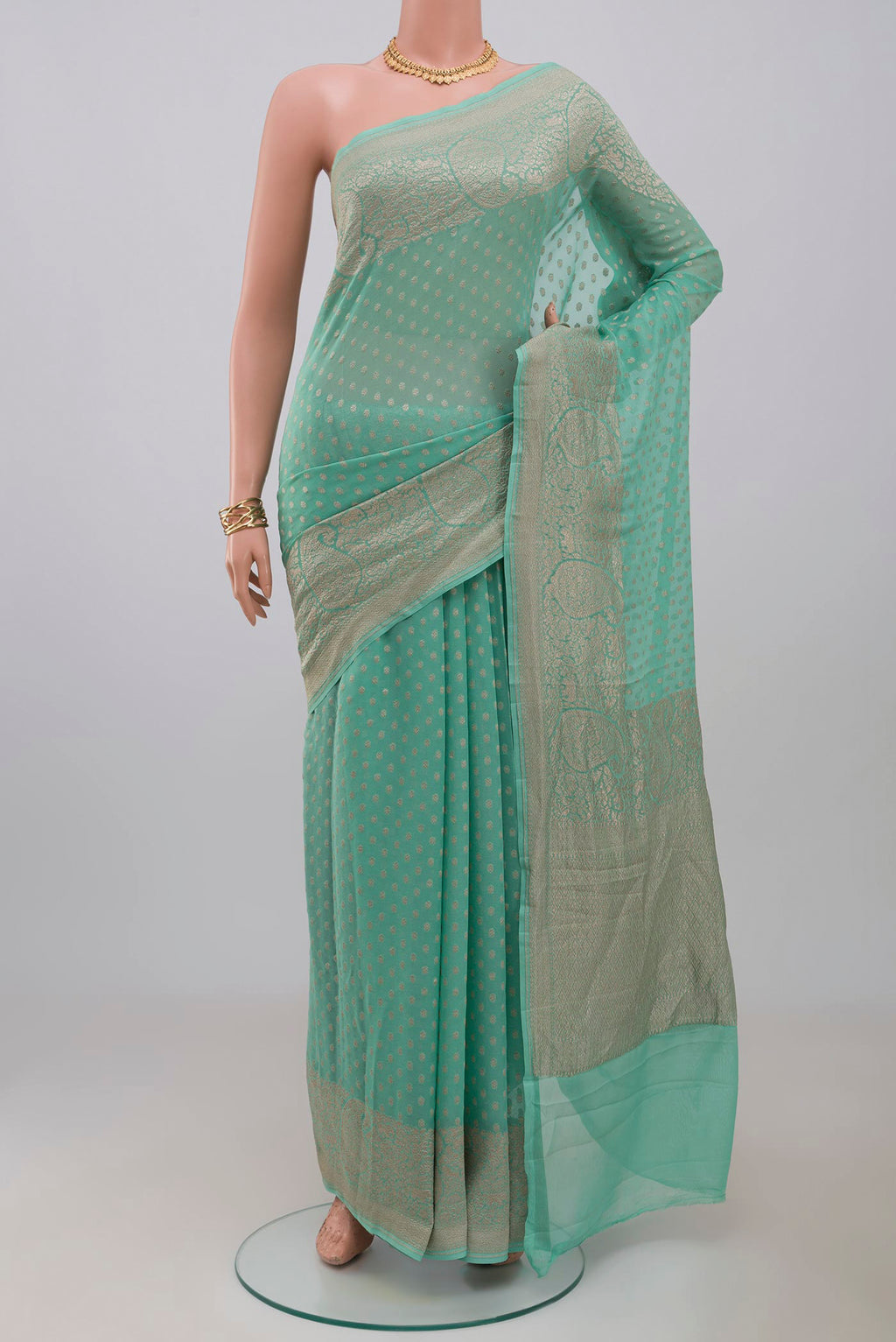 Blue Georgette Saree with Fancy on the body and Fancy Border.  displayed on a mannequin