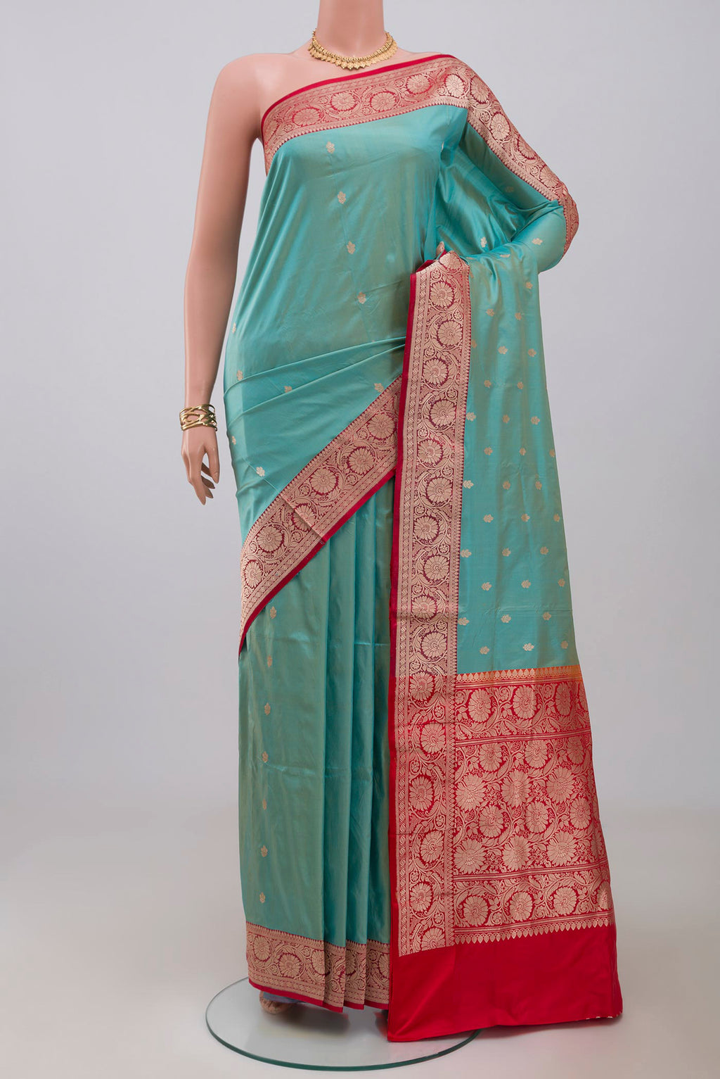 Blue Banarasi Katan Silk Saree with Zari Butta on the body and Zari Border.  displayed on a mannequin
