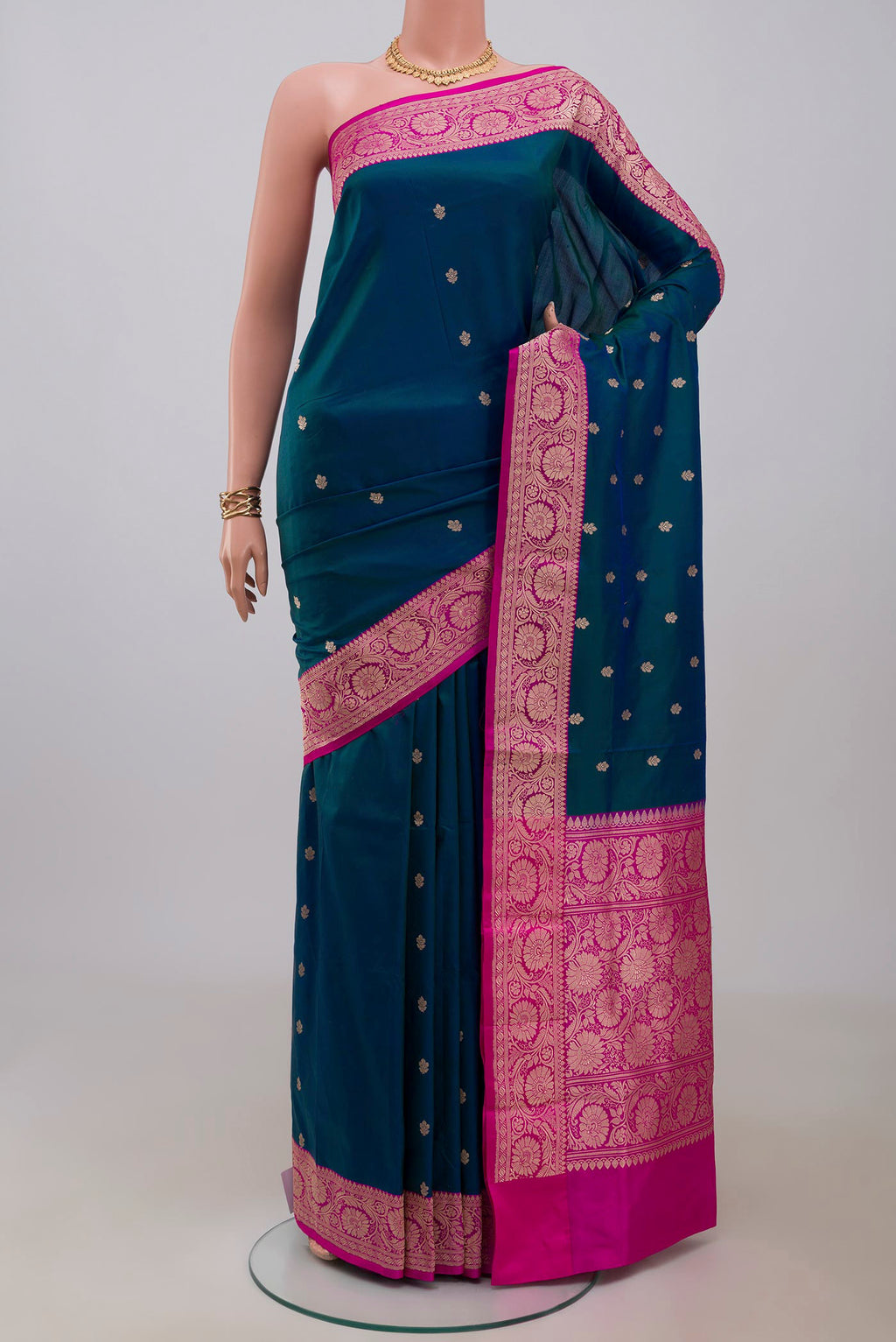 Blue Banarasi Katan Silk Saree with Zari Butta on the body and Fancy Border.  displayed on a mannequin