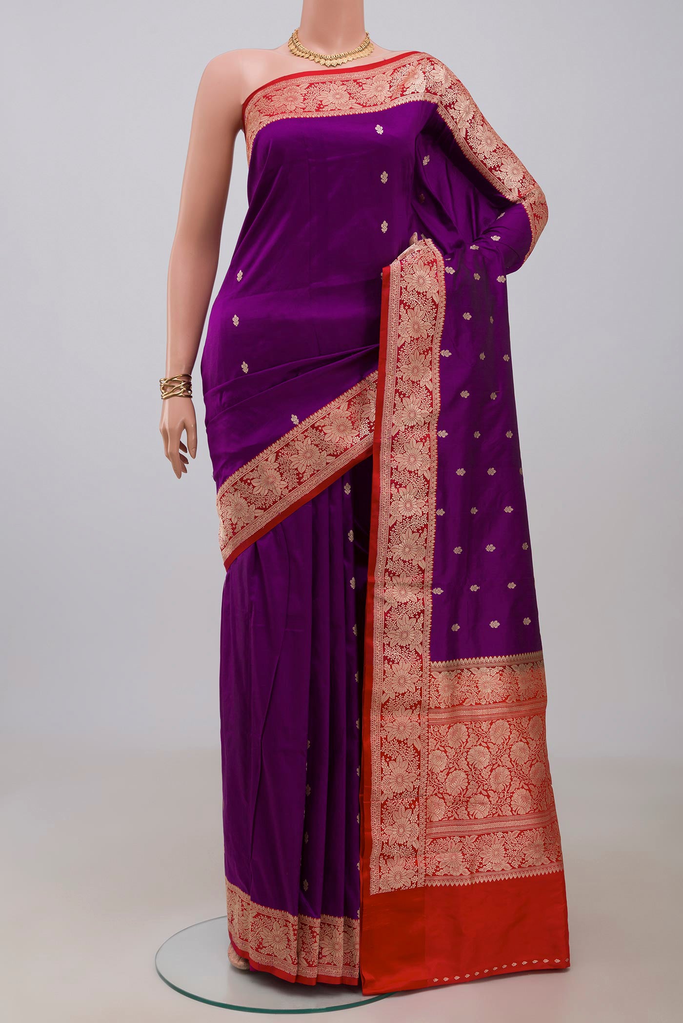 Purple Banarasi Katan Silk Saree with Zari Butta on the body and Fancy Border.  displayed on a mannequin