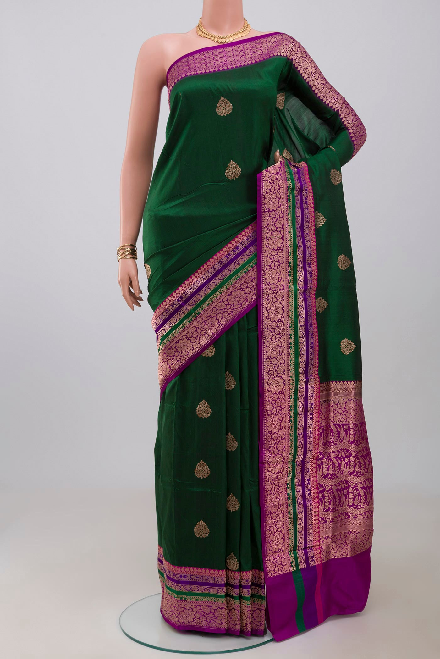 Green Banarasi Katan Silk Saree with Zari Butta on the body and Fancy Border.  displayed on a mannequin