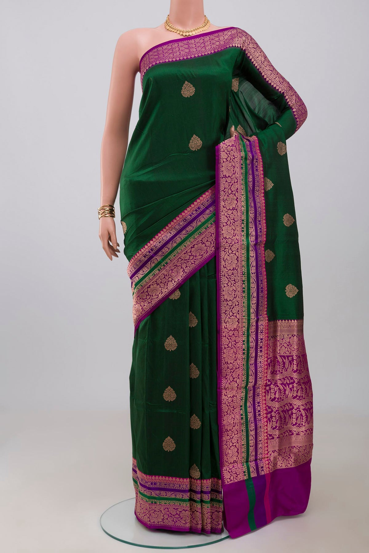 Green Banarasi Katan Silk Saree with Zari Butta on the body and Fancy Border.  displayed on a mannequin